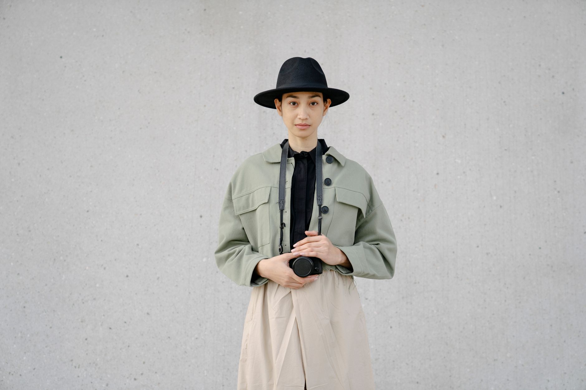 Model wearing a relaxed, unlined blazer with simple tonal separates