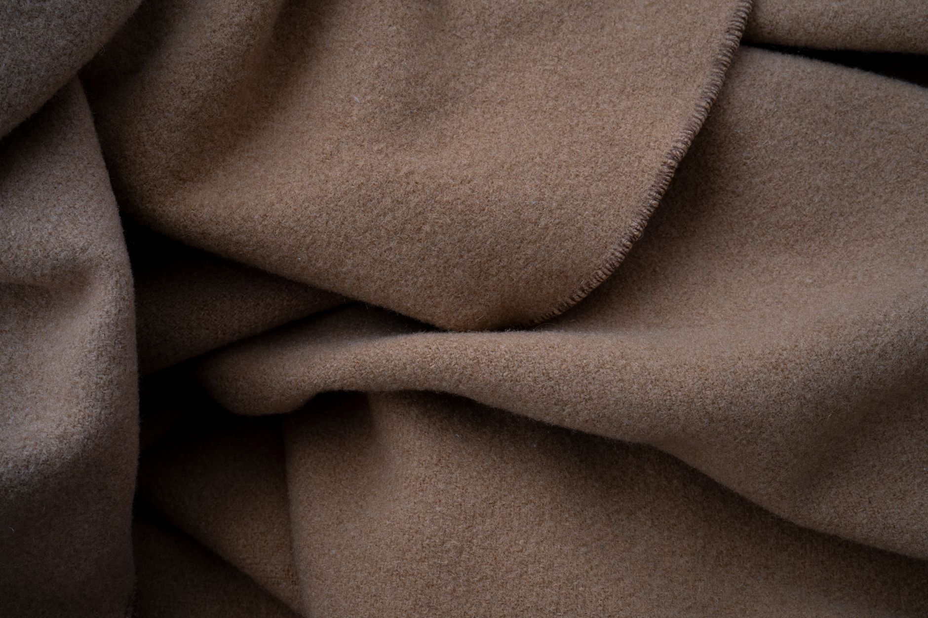 Close-up of soft cashmere fabric in a natural undyed tone