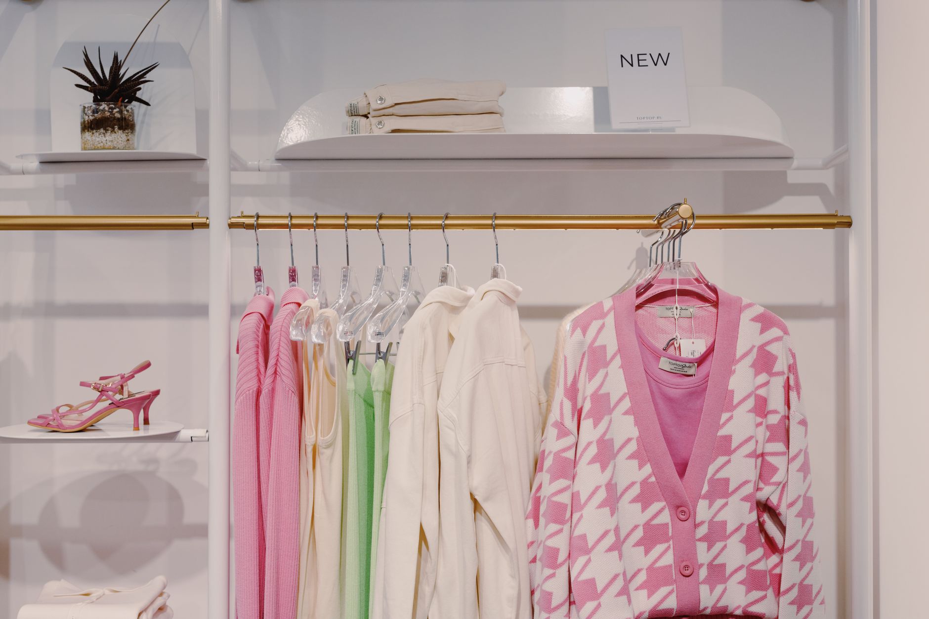 Minimalist fashion retail interior with denim garments on display