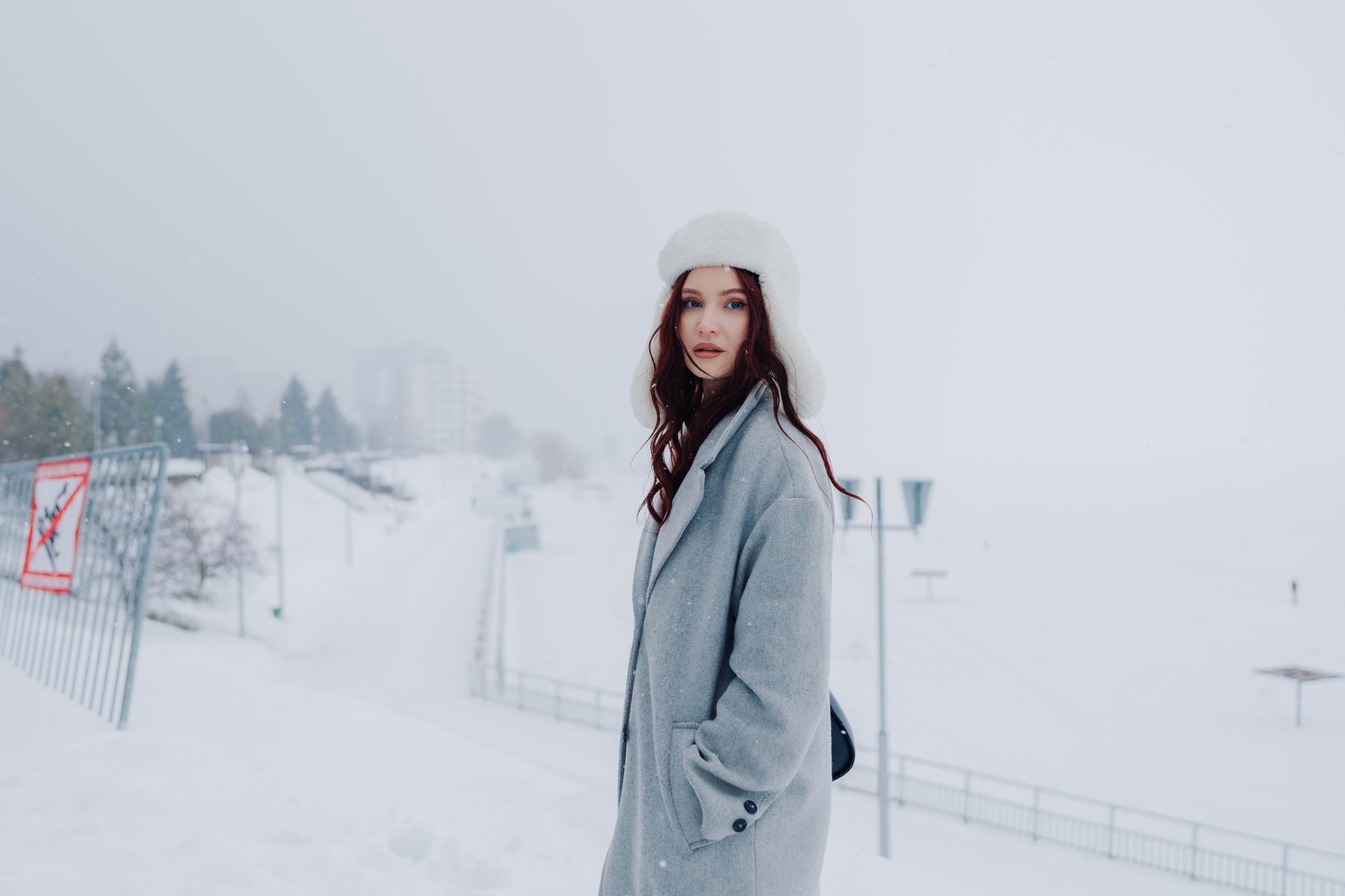 Minimal winter accessories arranged on a clean background showing leather textures