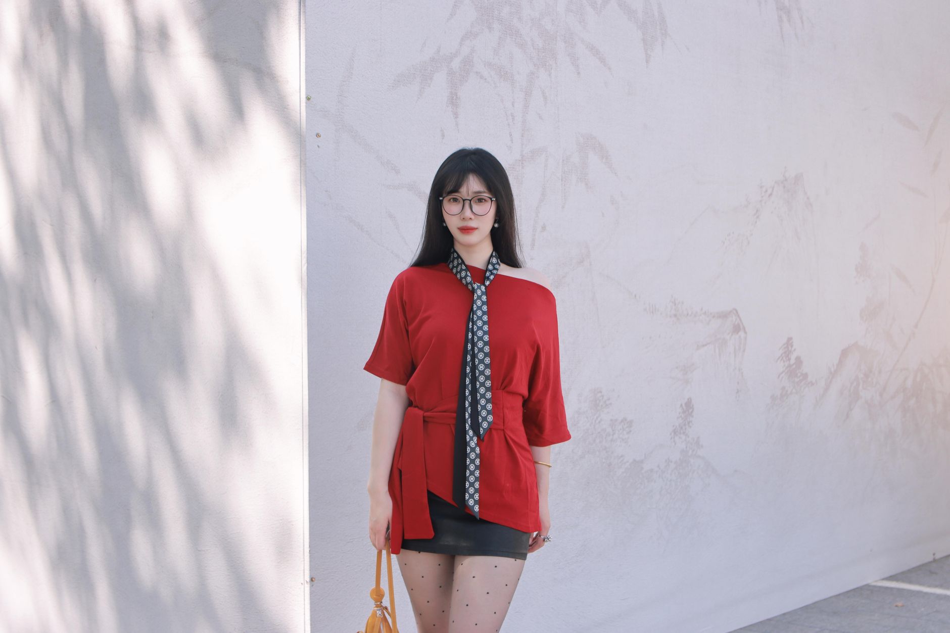 Fashion-forward outfit with tailored trousers and slip-on shoes captured on a city street