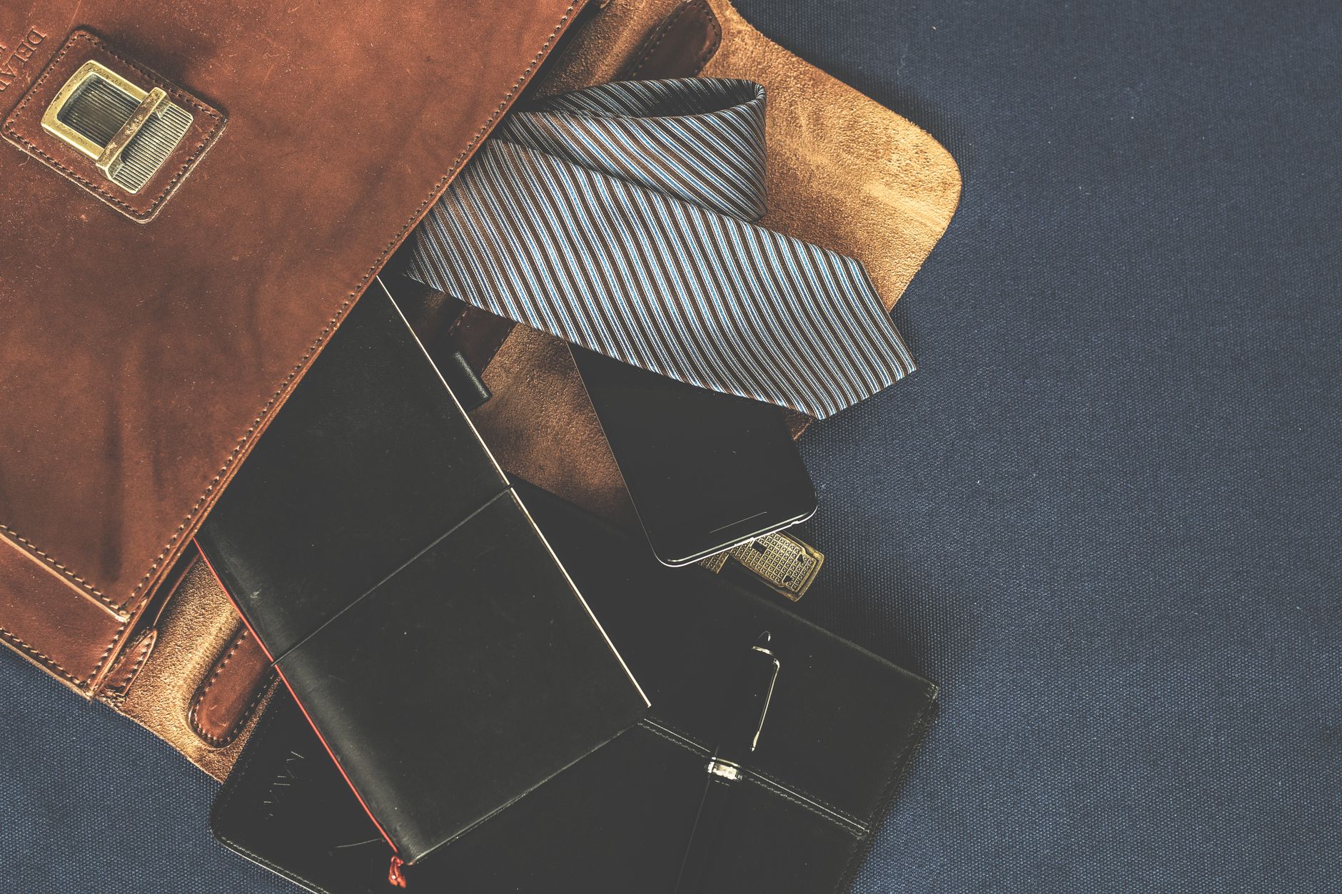 Luxury leather handbags displayed on a clean surface in soft natural light