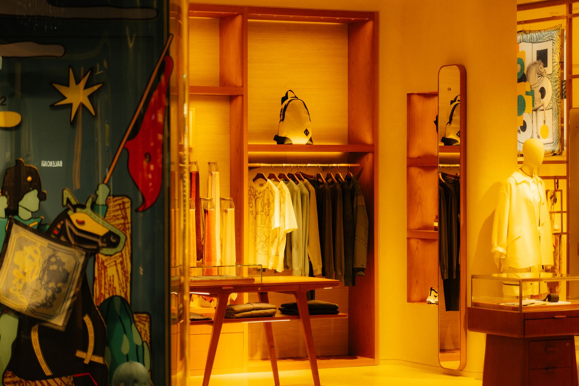 Neatly folded and hanging trousers and jeans displayed in a retail clothing store
