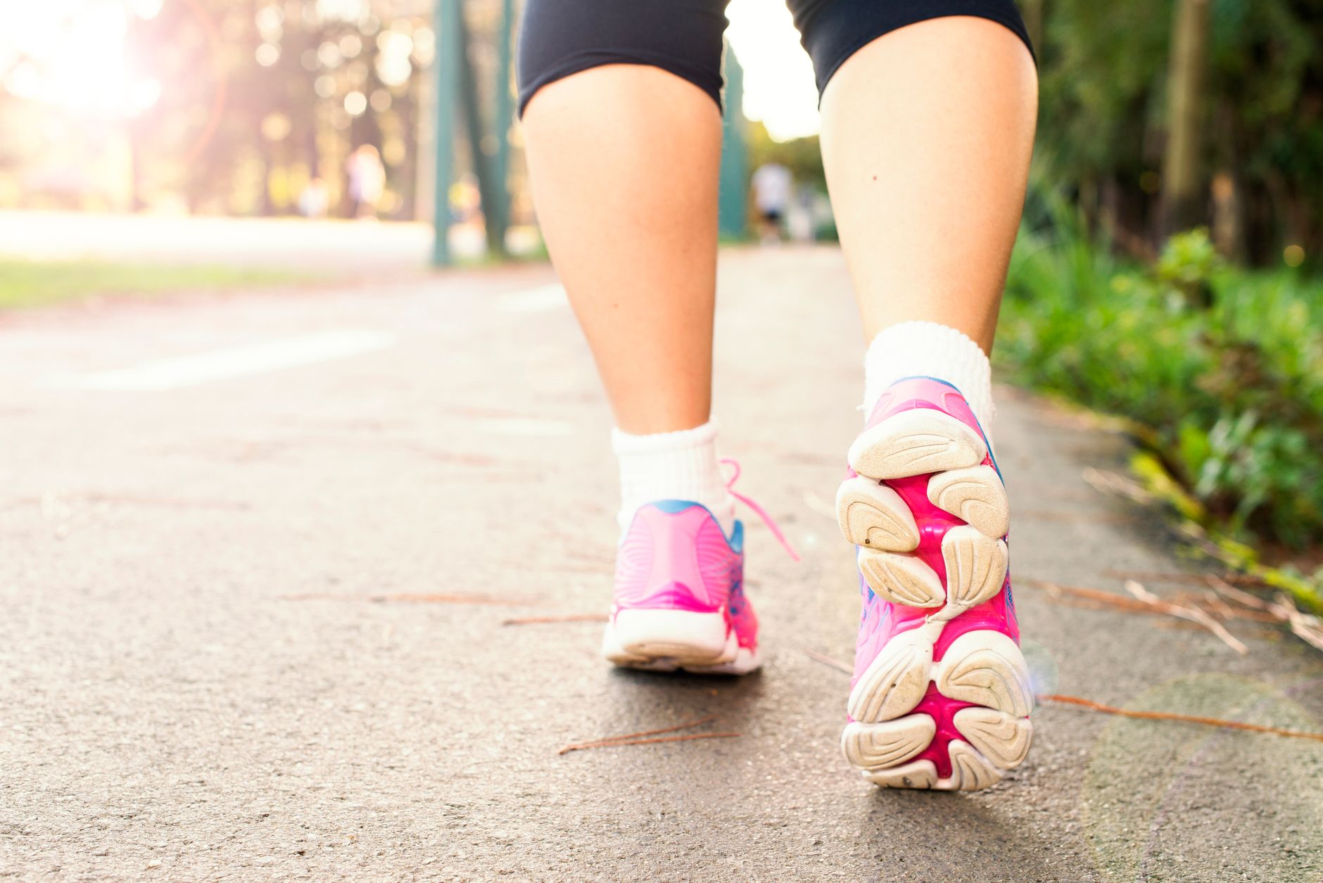 Close-up of a woman's feet in pointed-toe flats while walking on a city street