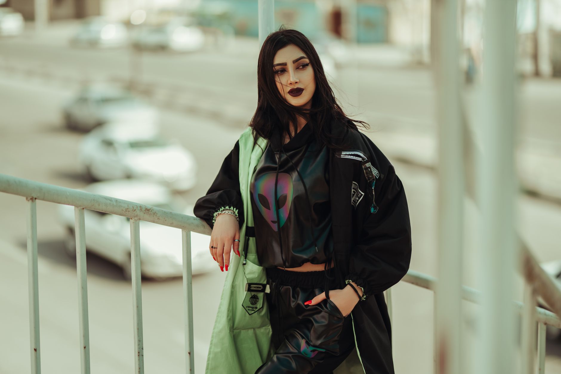 A woman in relaxed trousers carrying a leather shoulder bag on a city street