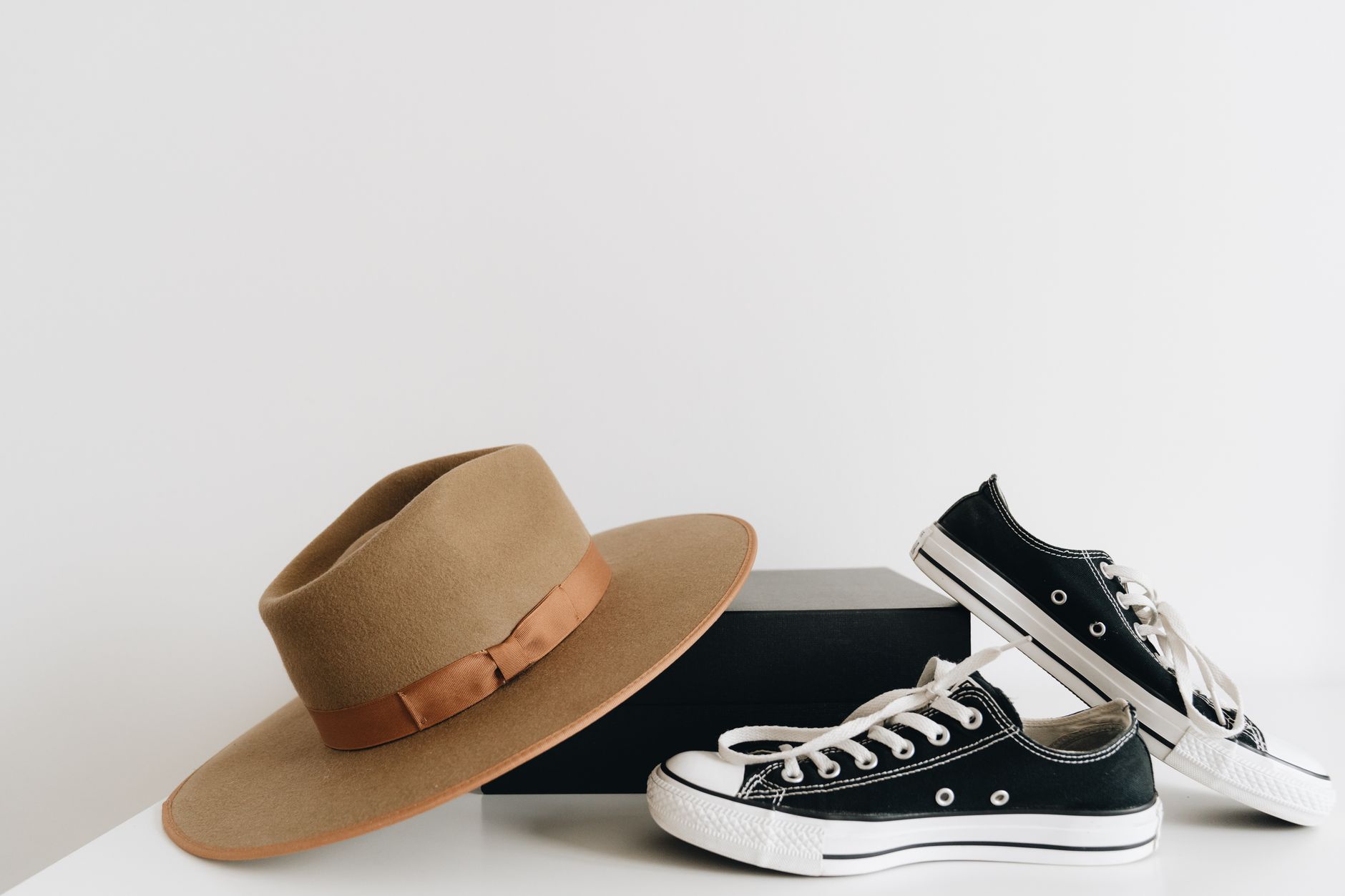 Neutral-toned flat shoes arranged on a minimalist background