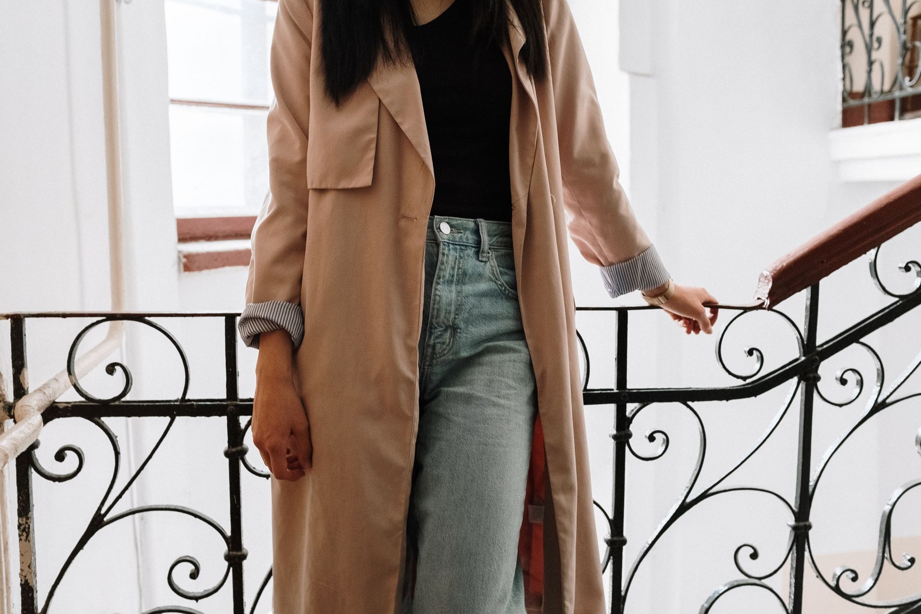 A person wearing a relaxed boxy shirt with tailored trousers and loafers