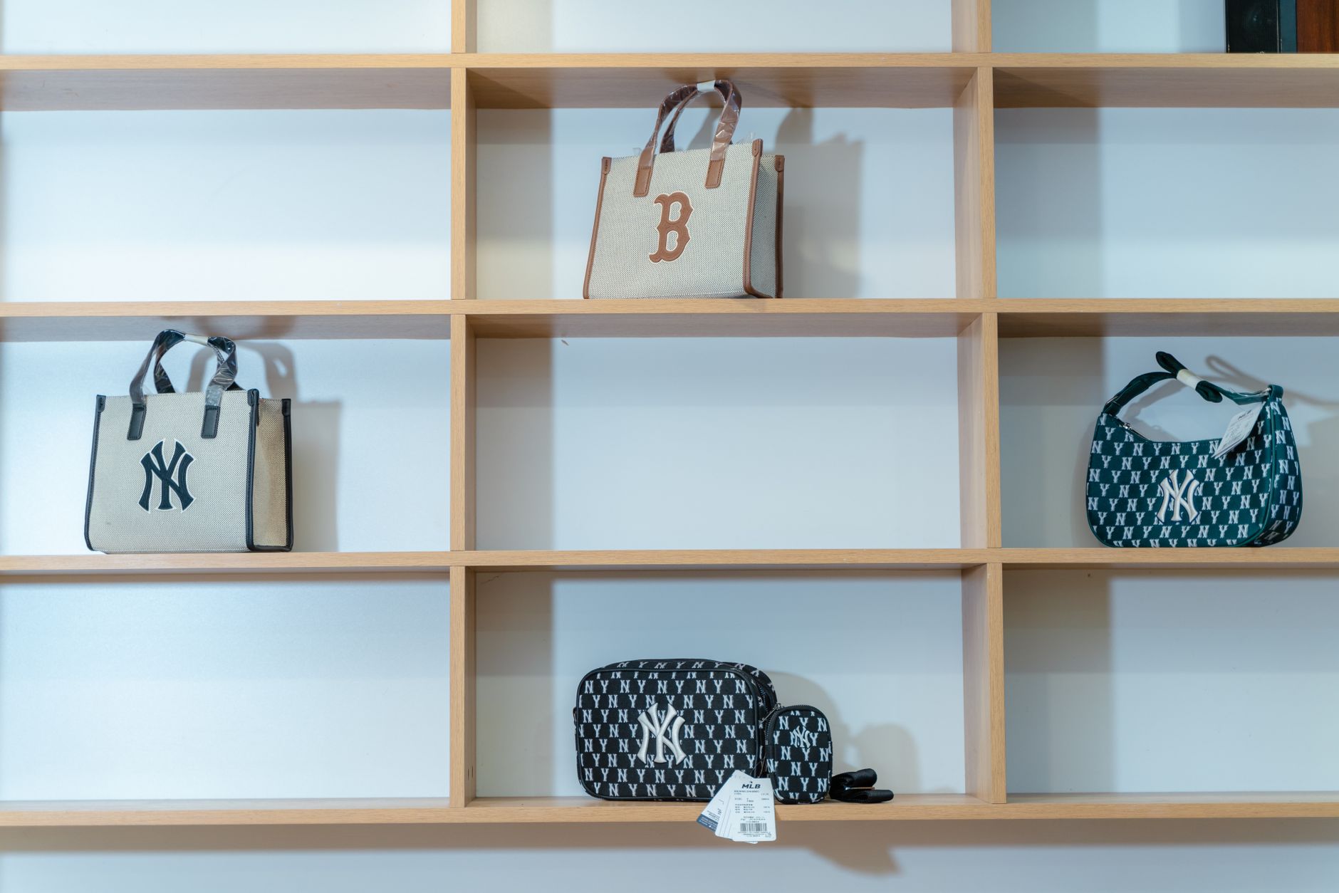 Luxury handbags displayed on shelves inside a high-end boutique