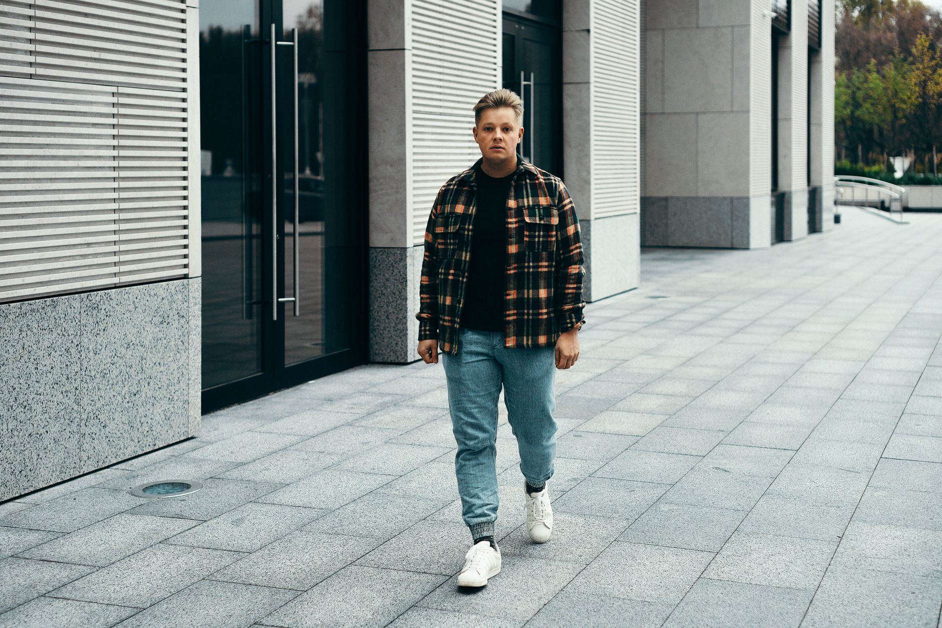 Person wearing relaxed-fit jeans styled with clean minimal separates