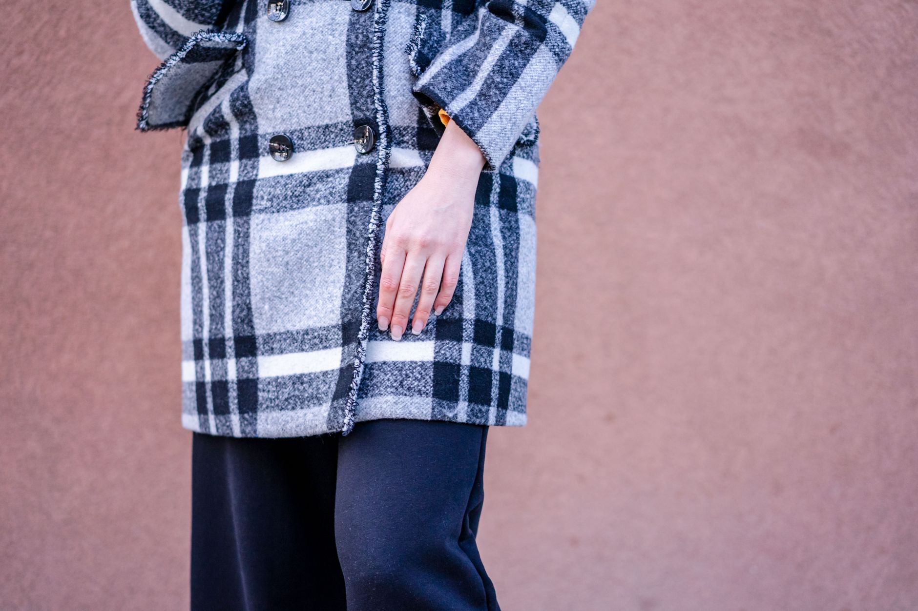 Detail shot of a tailored winter coat sleeve with fitted glove at the cuff