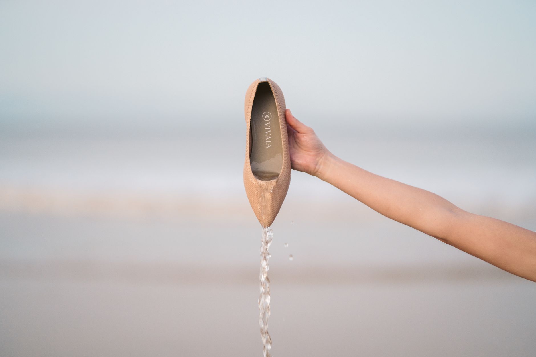 Minimalist flat shoes on a woman's feet against a clean background