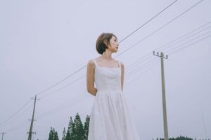 The Broderie Anglaise Dress Is Quietly Edging Out the Sundress A white broderie anglaise dress with eyelet embroidery detail hanging on a rack