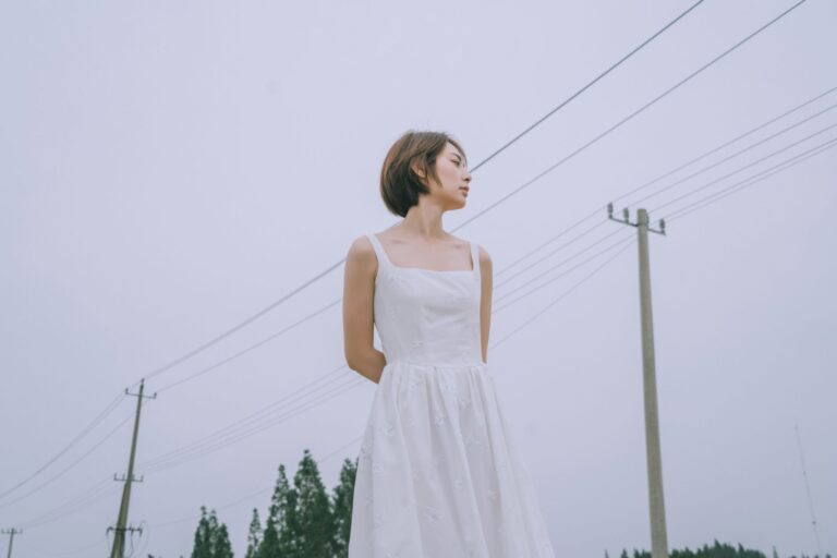 The Broderie Anglaise Dress Is Quietly Edging Out the Sundress A white broderie anglaise dress with eyelet embroidery detail hanging on a rack