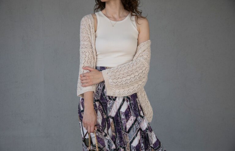 The Longline Cardigan Is Quietly Edging Out the Structured Coat Woman wearing an oversized longline cardigan as an outerwear layer over tailored trousers