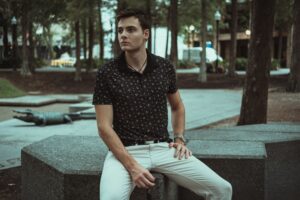 The Knit Polo Is Quietly Edging Out the Classic Crewneck A neatly folded knit polo shirt in a neutral tone displayed on a flat surface