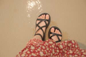 The Flat Sandal Is Quietly Edging Out the Wedge Espadrille Minimal flat leather sandals on a light background, representing summer footwear trends