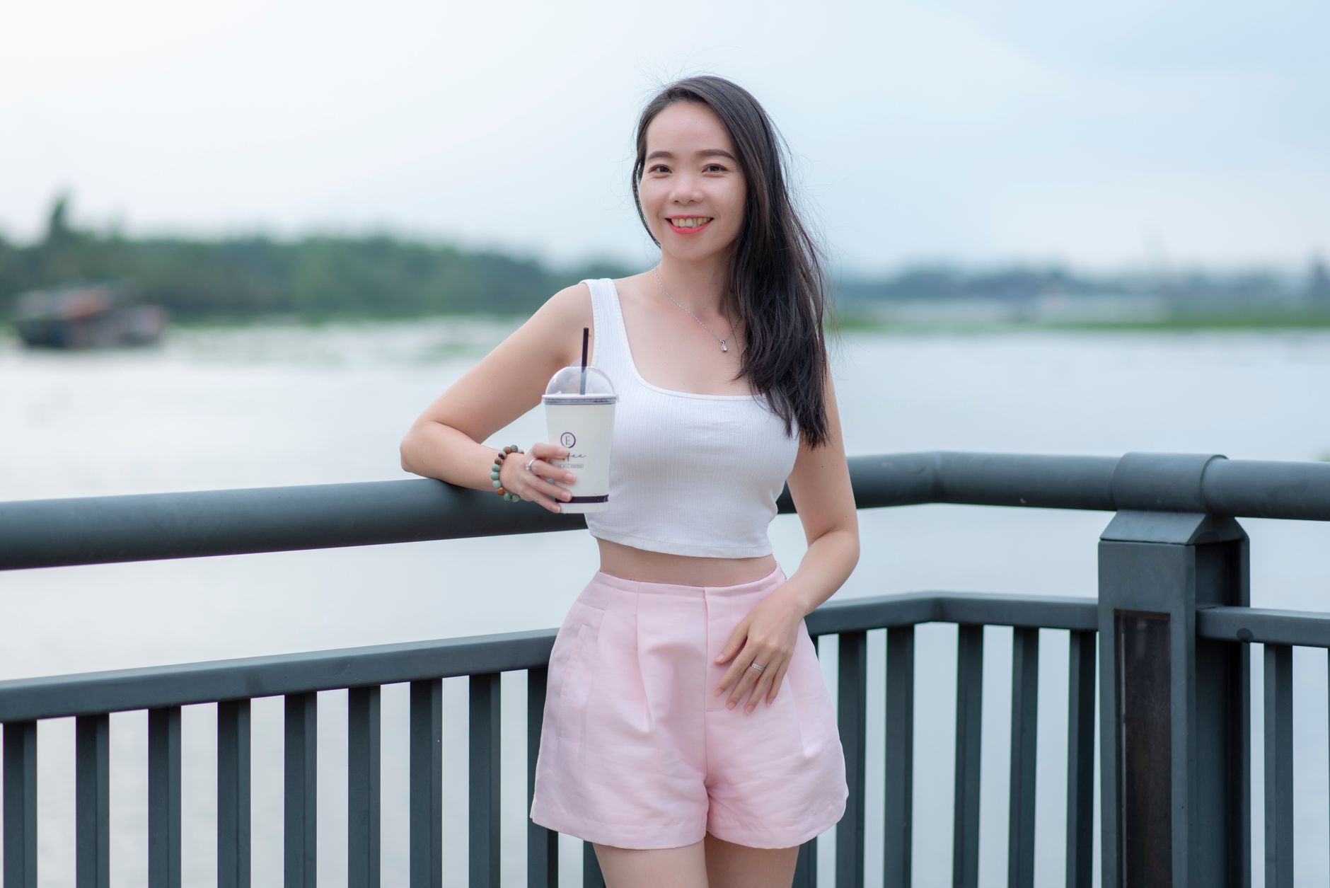 White broderie anglaise shorts laid flat on a light surface showing eyelet embroidery detail