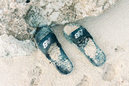 The Slide Sandal Is Quietly Edging Out the Fisherman Sandal A pair of minimalist leather slide sandals on a neutral background
