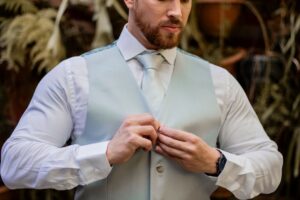 The Broderie Anglaise Waistcoat Is Quietly Edging Out the Tailored Vest A white broderie anglaise waistcoat laid flat, showing delicate eyelet embroidery detail