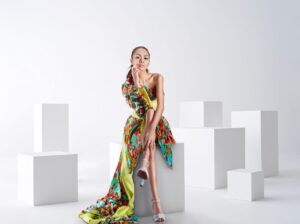 The Asymmetric Hem Dress Is Quietly Edging Out the Midi Skirt A woman wearing a modern asymmetric hem dress with a diagonal hemline, styled minimally
