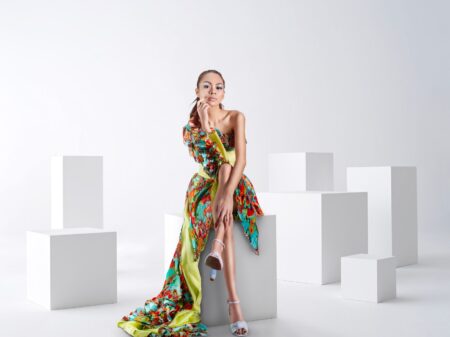 The Asymmetric Hem Dress Is Quietly Edging Out the Midi Skirt A woman wearing a modern asymmetric hem dress with a diagonal hemline, styled minimally