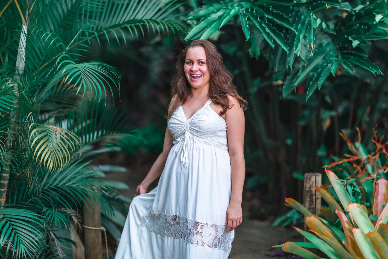 The Broderie Anglaise Maxi Dress Is Quietly Edging Out the Linen Shirt Dress Woman wearing a white broderie anglaise maxi dress outdoors in natural light