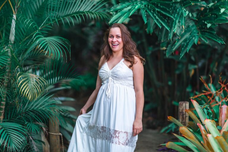 The Broderie Anglaise Maxi Dress Is Quietly Edging Out the Linen Shirt Dress Woman wearing a white broderie anglaise maxi dress outdoors in natural light