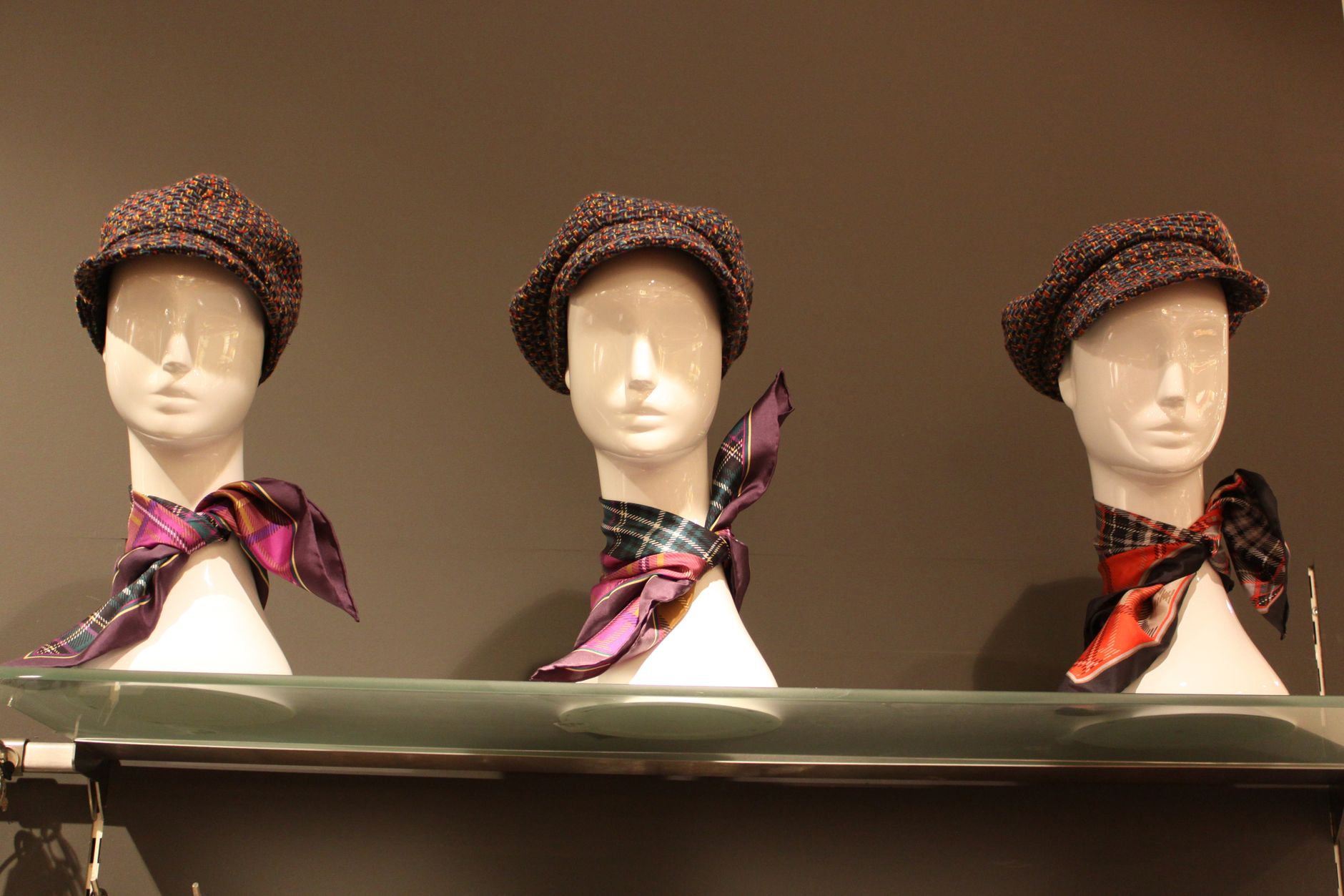 A collection of structured and soft handbags arranged on display shelving