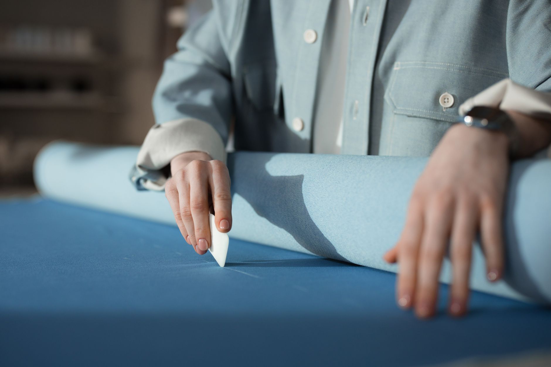 Detailed view of visible contrast thread stitching on tailored trousers