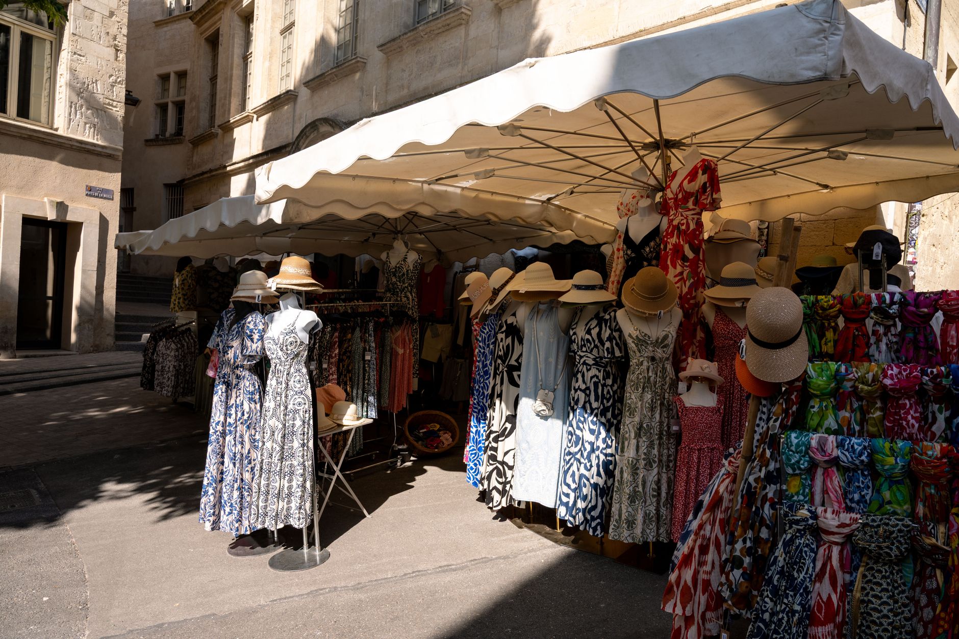 Light cotton dresses displayed in a boutique setting with natural light