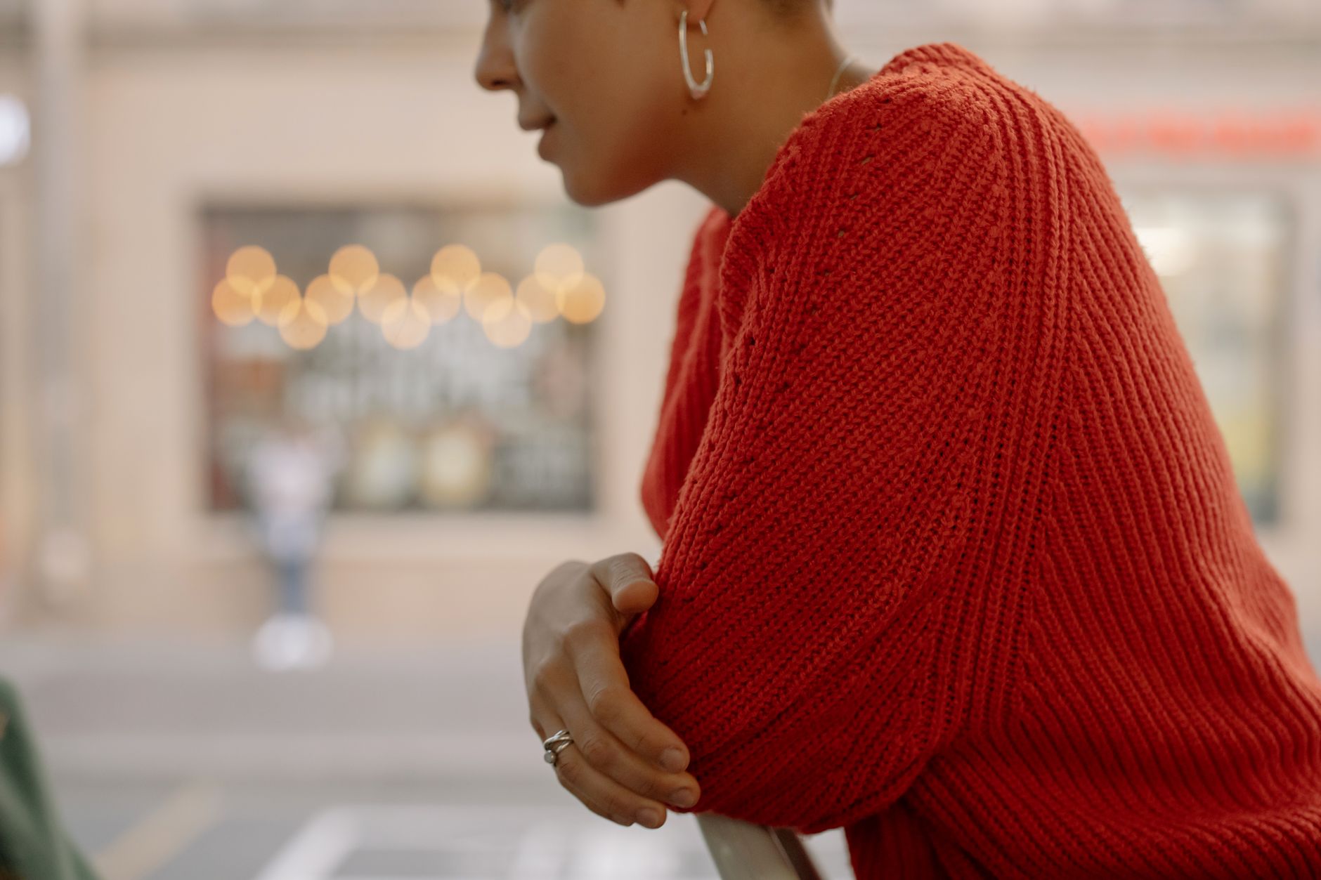 Close-up of a chunky textured knit cardigan in neutral tones laid flat