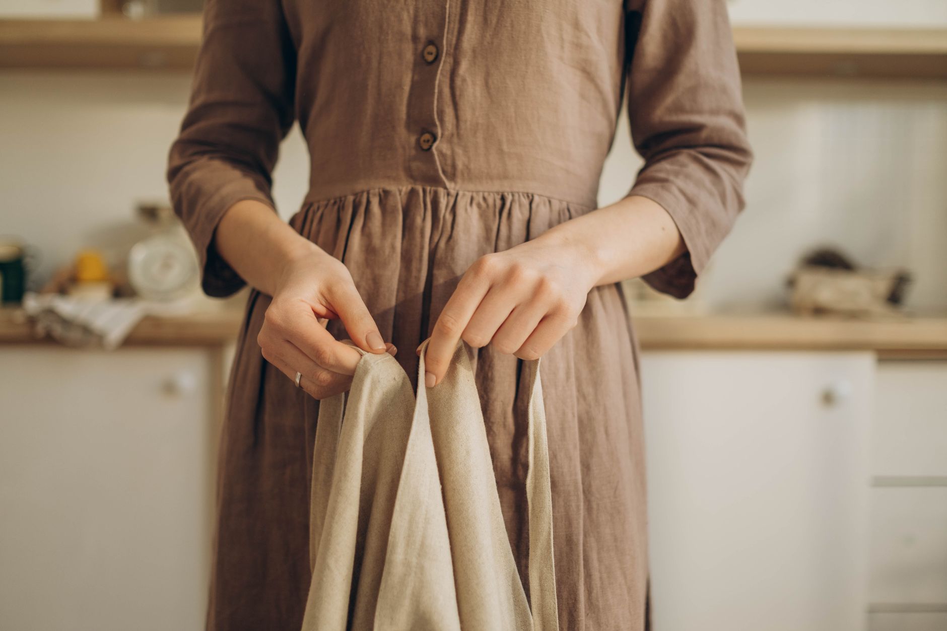 Woman wearing a relaxed linen outfit cinched at the waist with an earth-toned belt