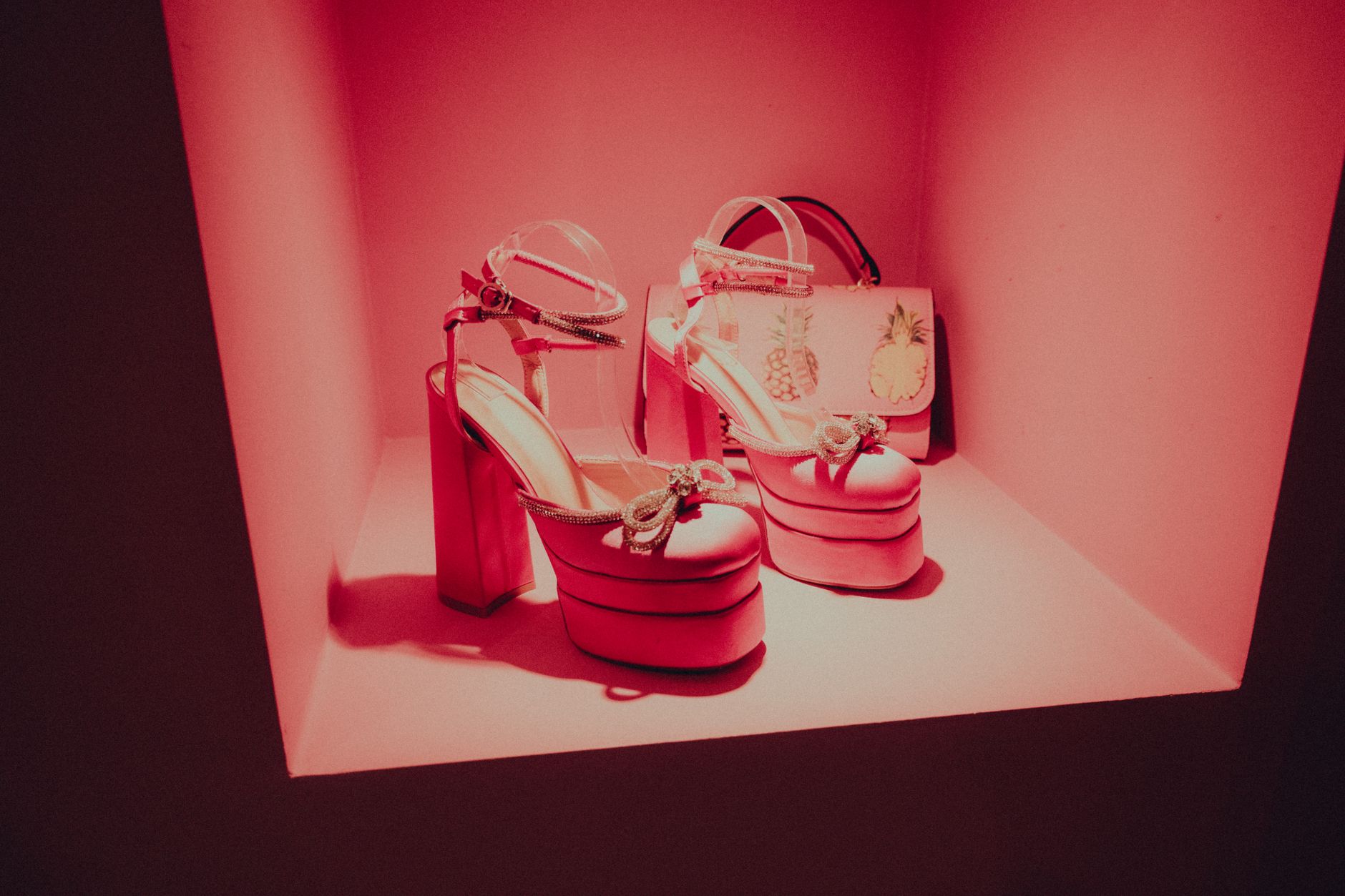 Row of heeled ankle boots displayed in a fashion retail setting