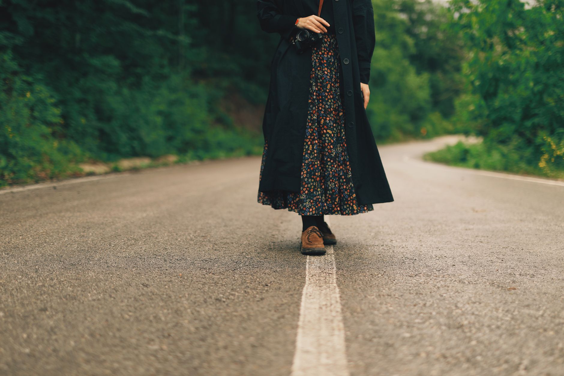 Woman wearing a midi skirt and flat shoes in a street style setting