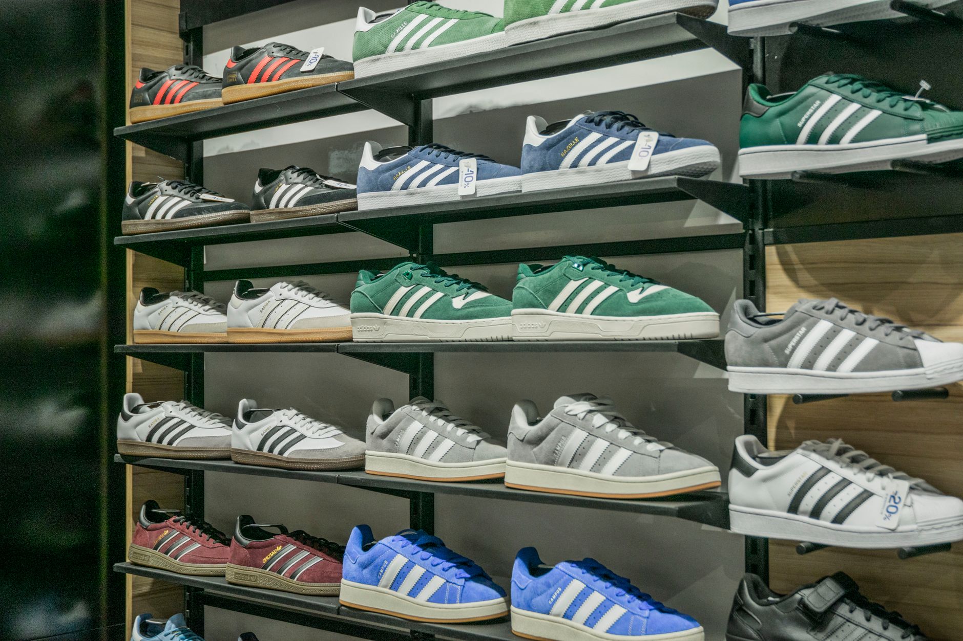 Footwear retail display featuring ankle boot styles in multiple colors