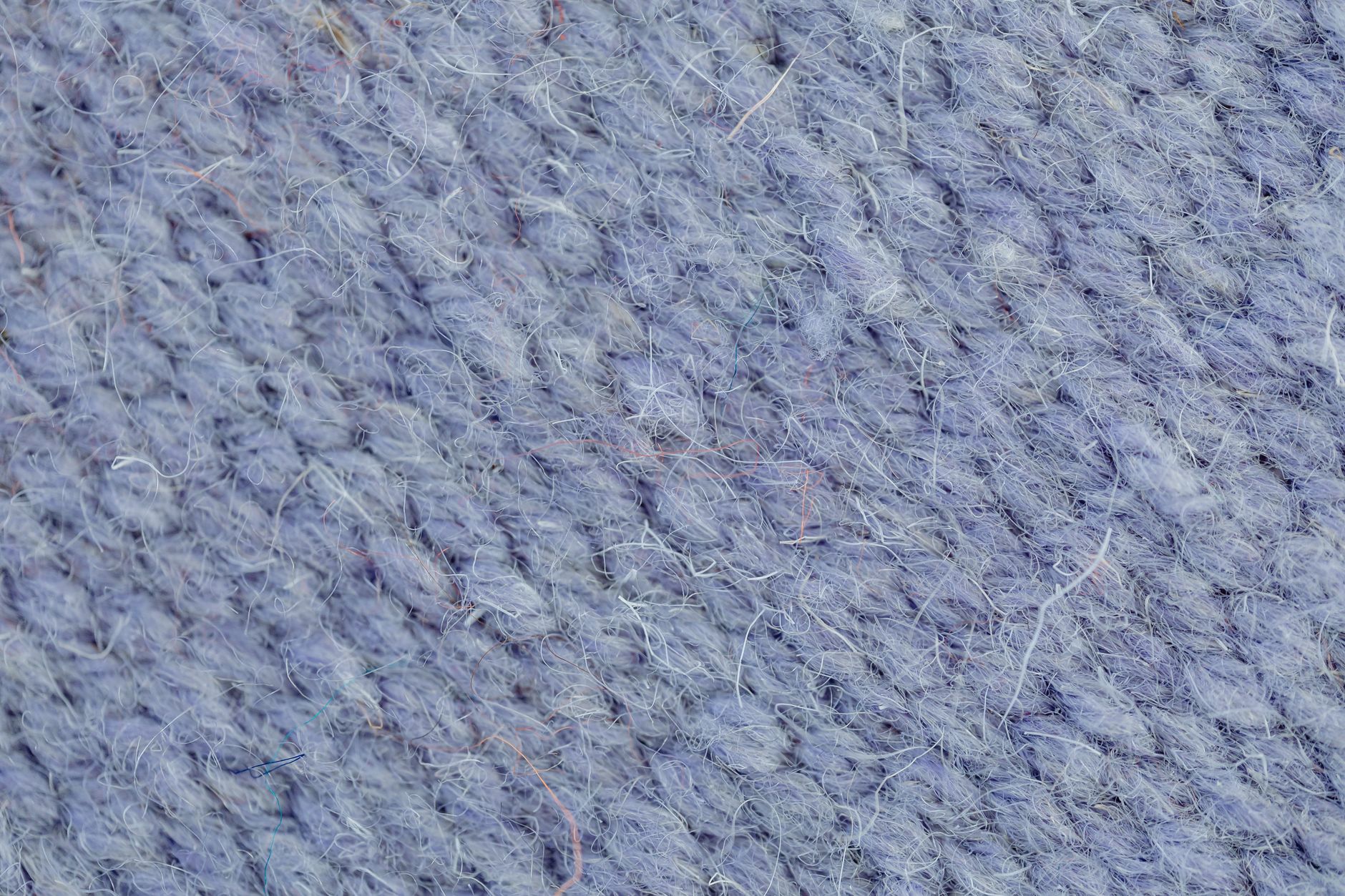Close-up of natural linen fabric texture showing characteristic slub and weave