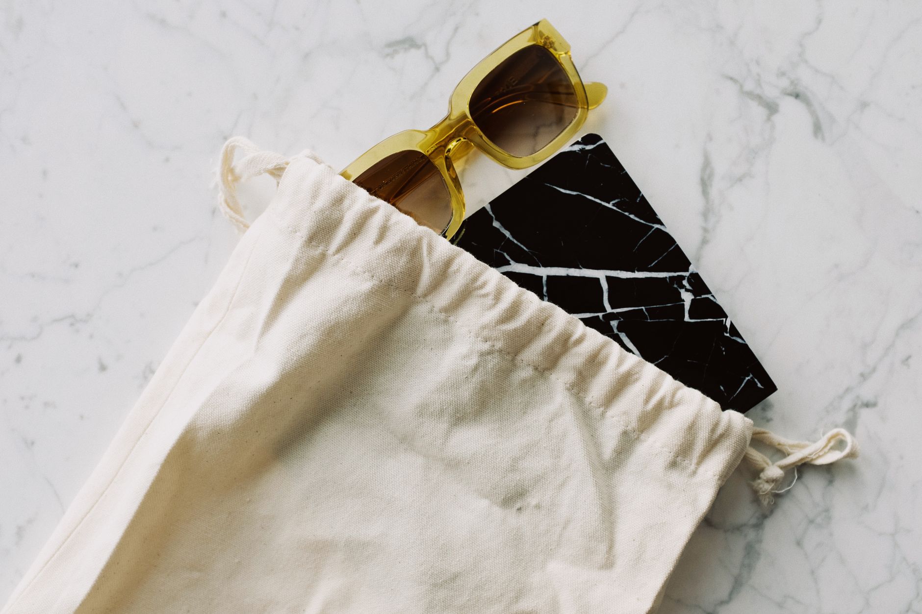 A flat lay of warm-weather bags and accessories including textured totes and woven styles