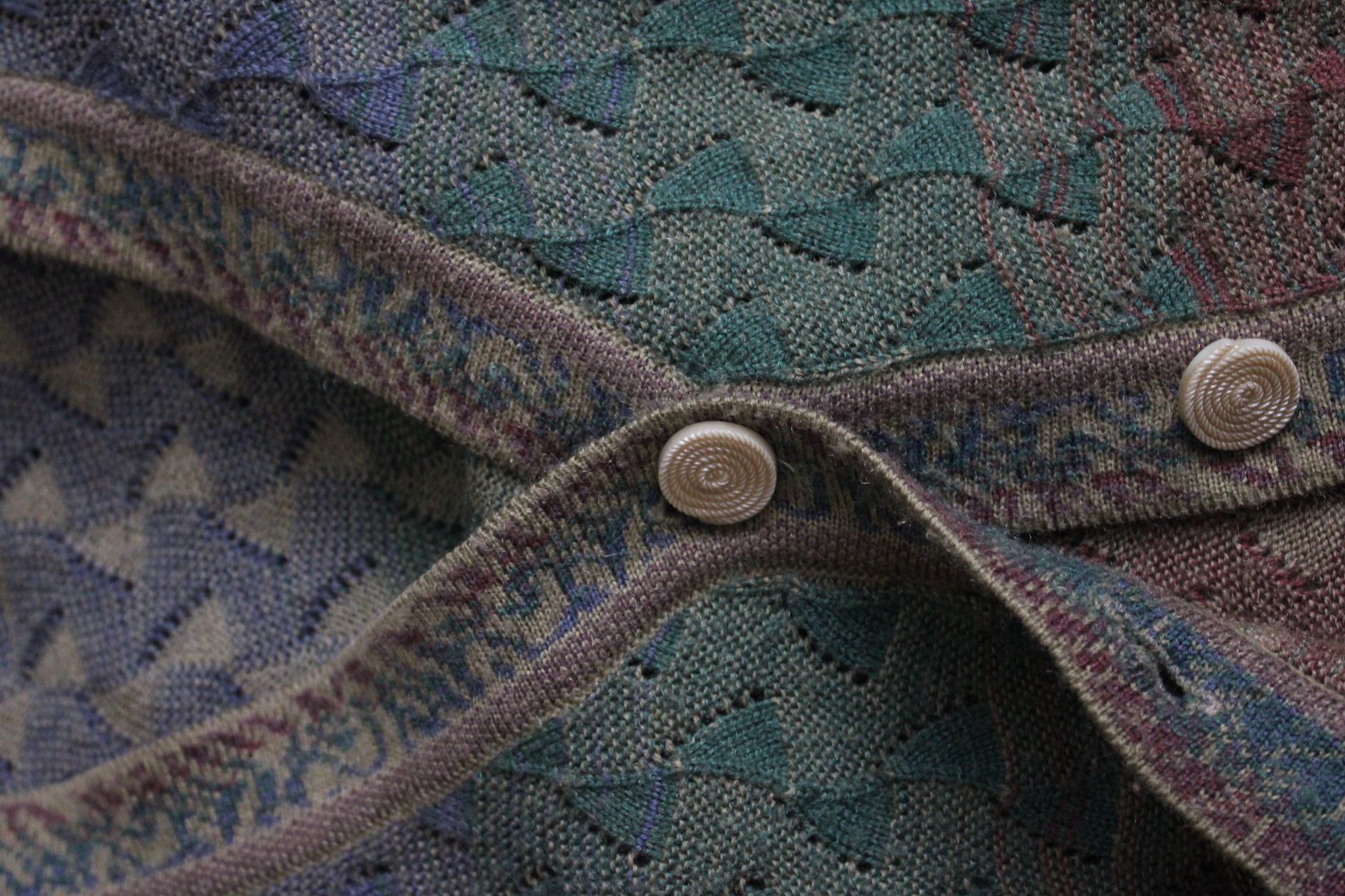 Close-up of fine-gauge knitwear texture showing collar detail on a sweater