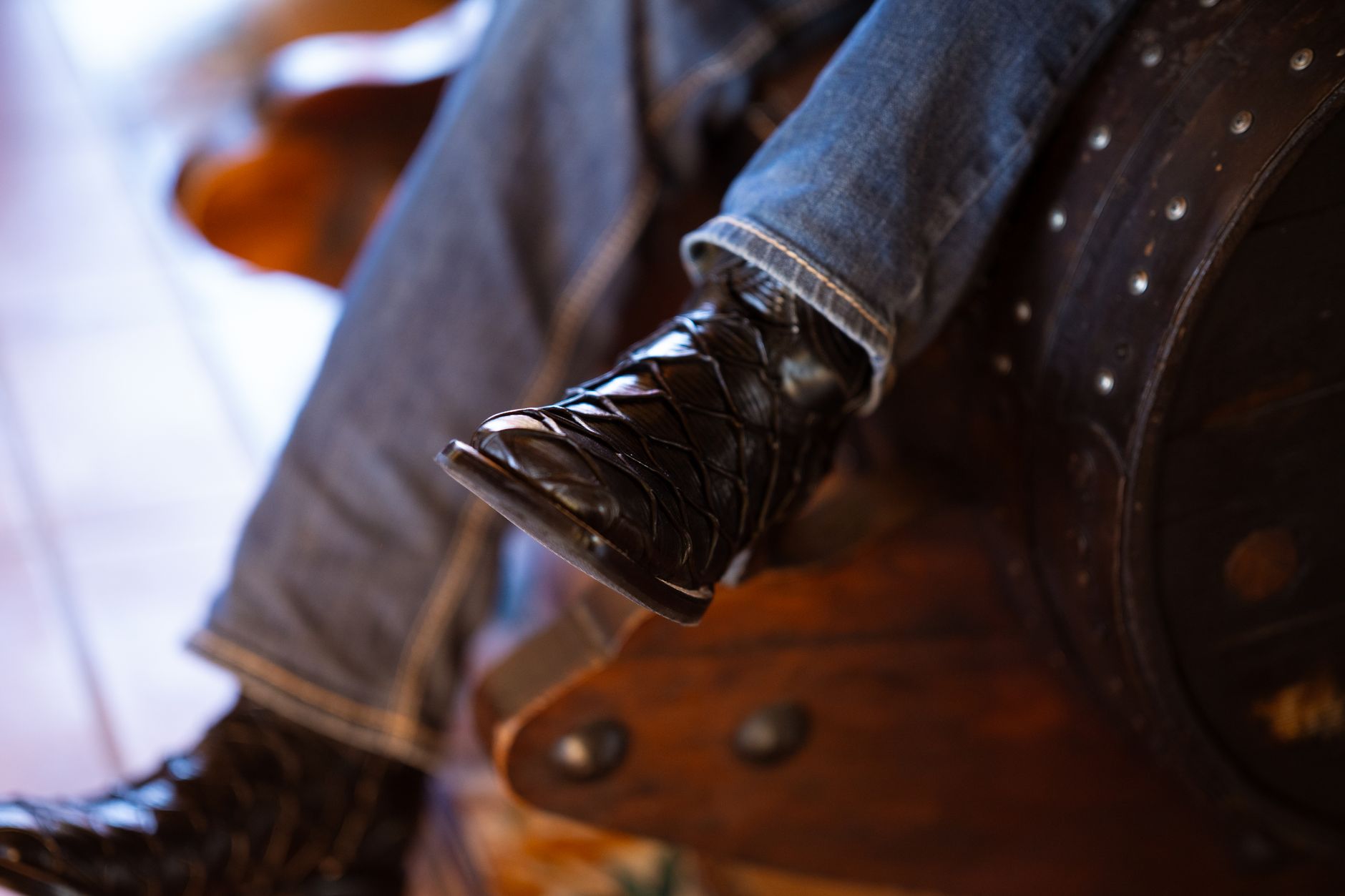 Detail shot of a slim-heeled ankle boot against a neutral background