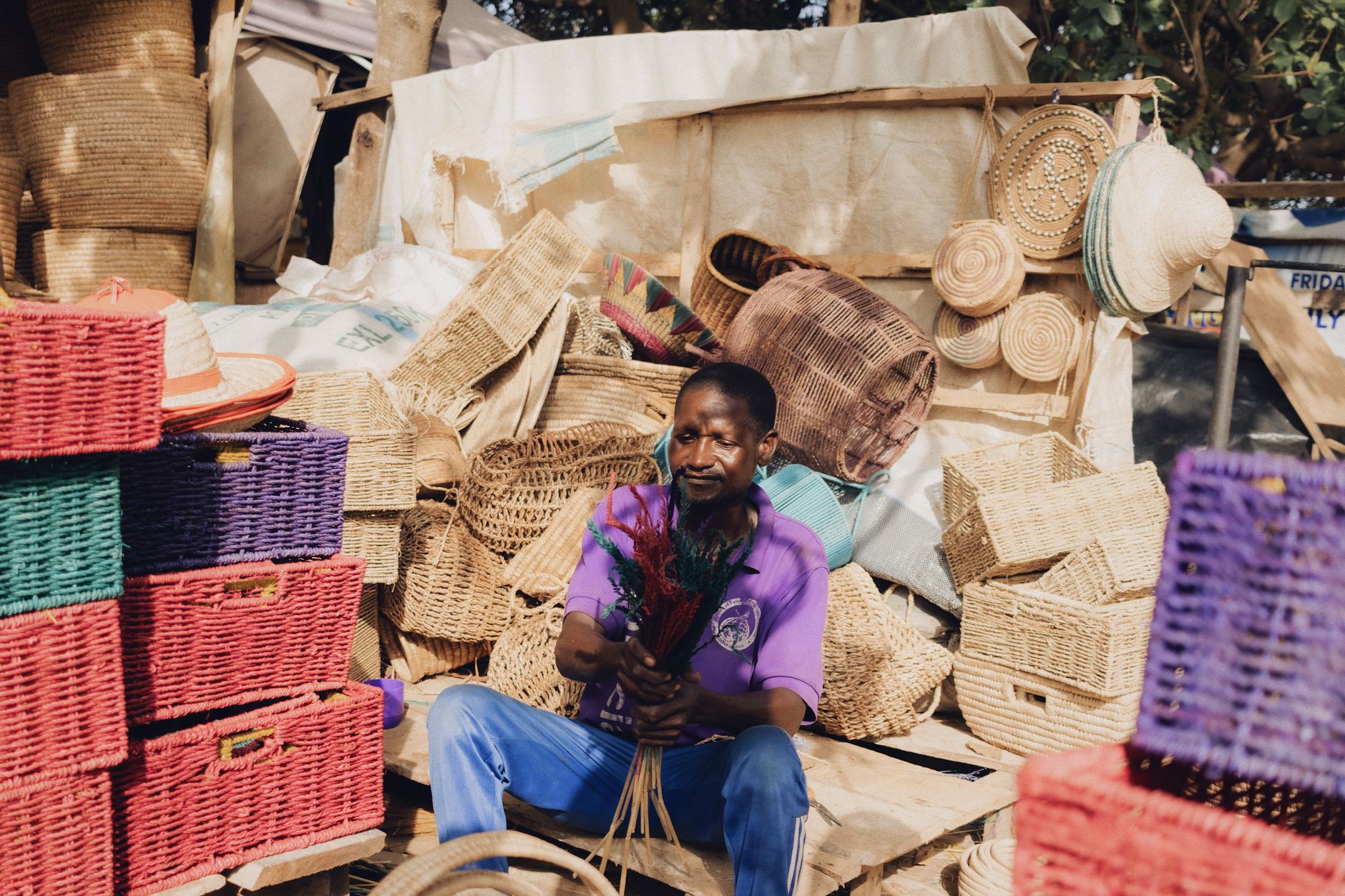 Selection of handwoven raffia and natural fiber bags displayed at a market stall