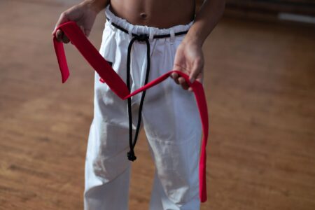 The Broderie Anglaise Belt Is Quietly Edging Out the Leather Waist Cincher A delicate white broderie anglaise belt laid flat on a light fabric surface