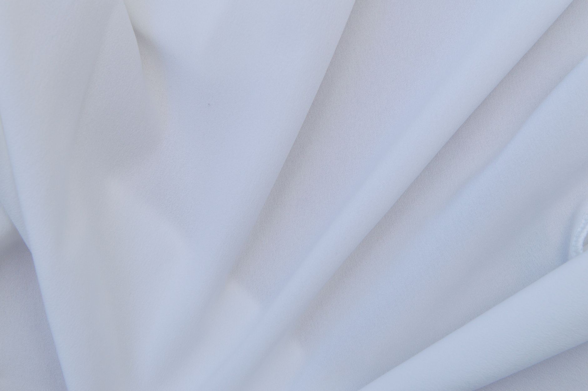 Close-up of broderie anglaise fabric with delicate eyelet embroidery detail