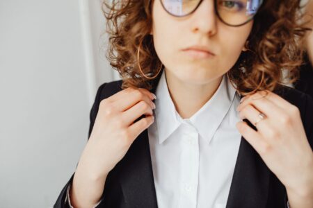 The Broderie Anglaise Collar Is Quietly Edging Out the Peter Pan Neckline Close-up of a white embroidered collar on a feminine blouse