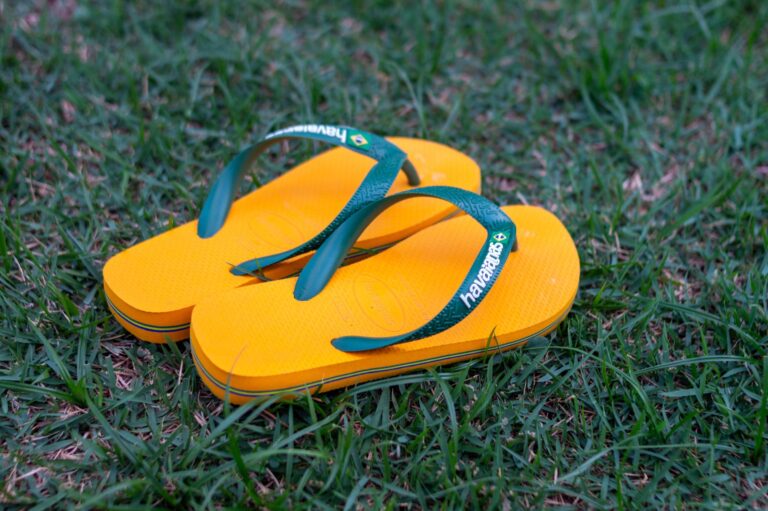 Close-up of feminine bow sandals on a light background, showing ankle strap detail