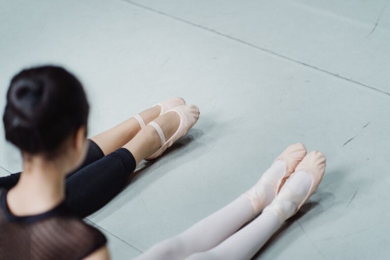 Close-up of a pair of delicate mesh ballet flats on a smooth floor