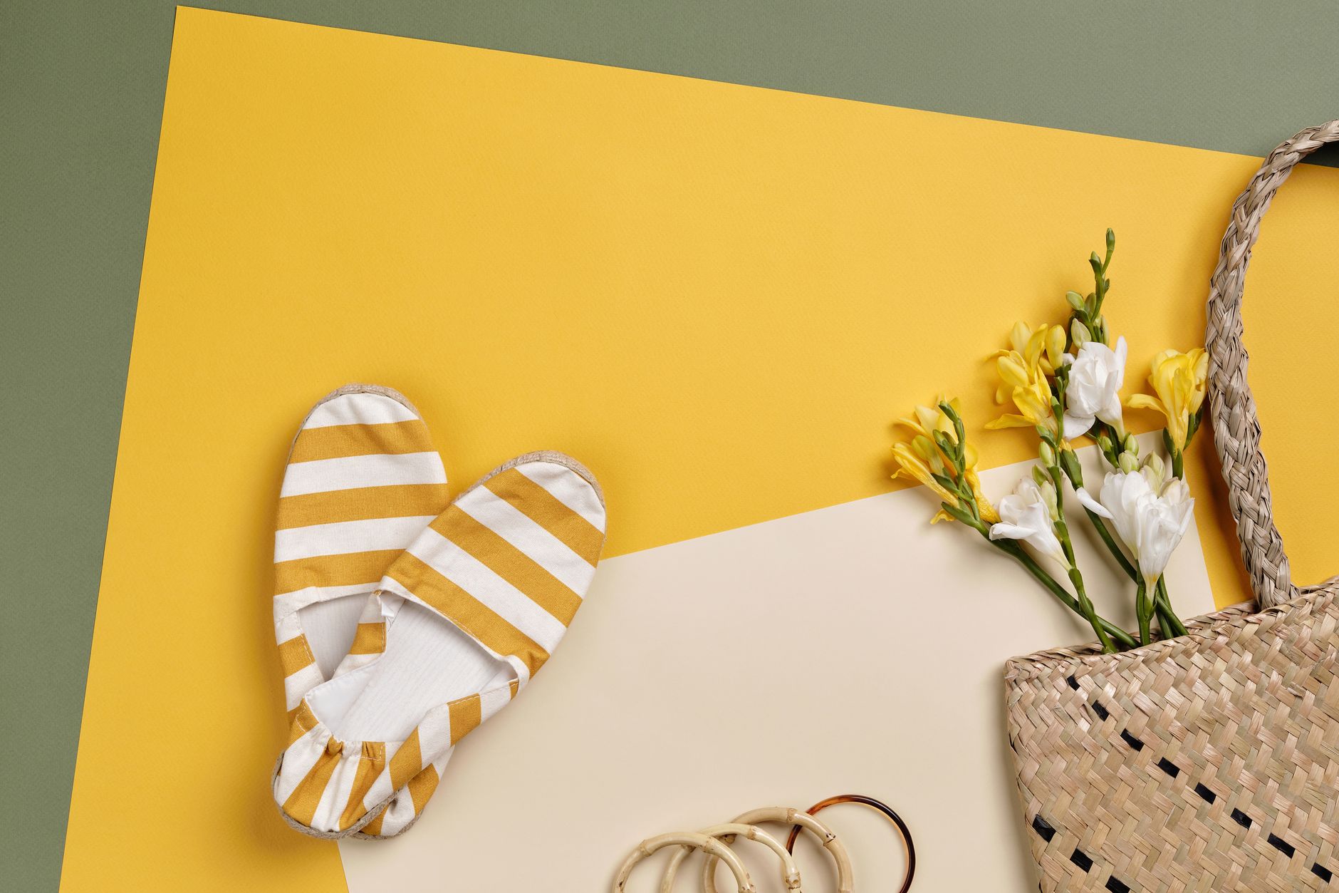 Close-up of raffia ballet flats in natural woven texture on a light surface