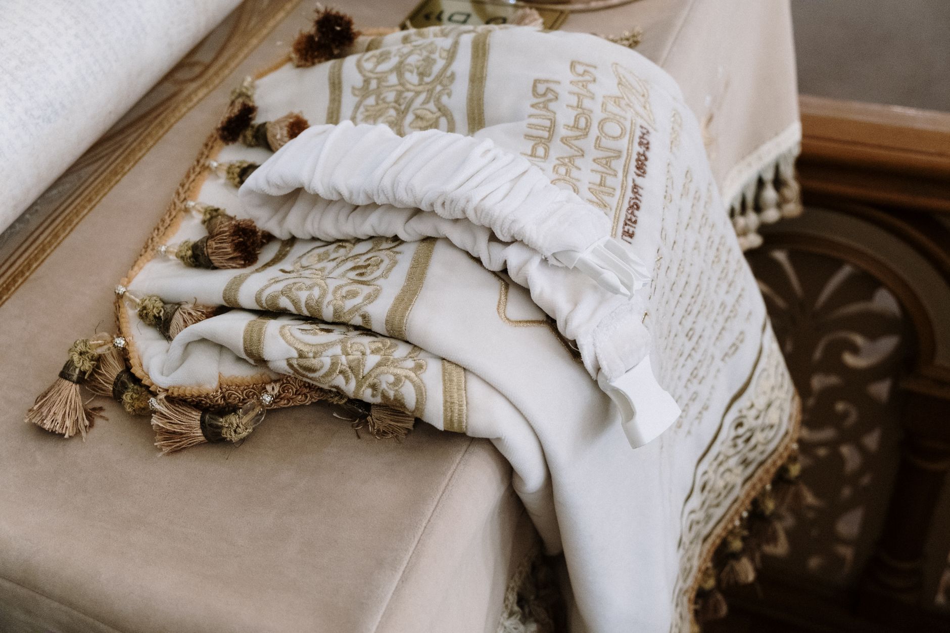 Close-up of white broderie anglaise fabric showing detailed eyelet embroidery