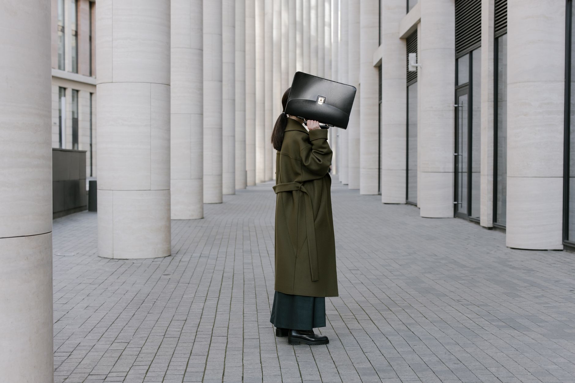 Street style outfit featuring layered knitwear and clean silhouettes in muted colors