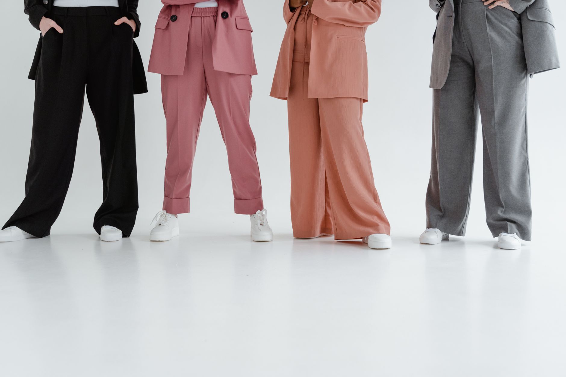 Woman wearing relaxed wide-leg white trousers in a summer fashion editorial setting