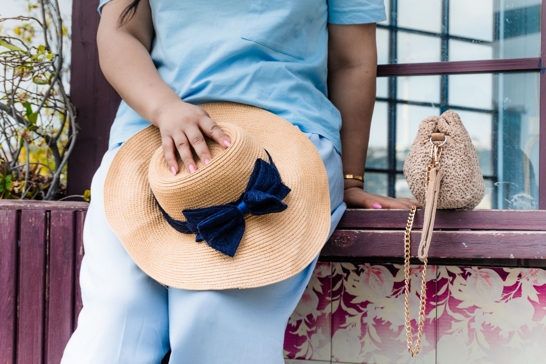 Close-up of a summer outfit featuring a flowy skirt and flat shoes with textured fabric